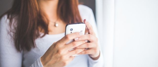 Woman booking appointment online using phone