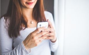 woman on phone booking appointment with therapist