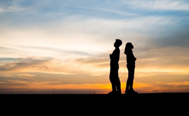 Upset couple - arms folded with backs to one another